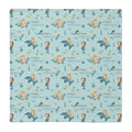 A square fabric item, likely a baby blanket or cloth, featuring a repeating pattern of mermaids, dolphins, and the personalized name 'anna catherine' on a light blue background.