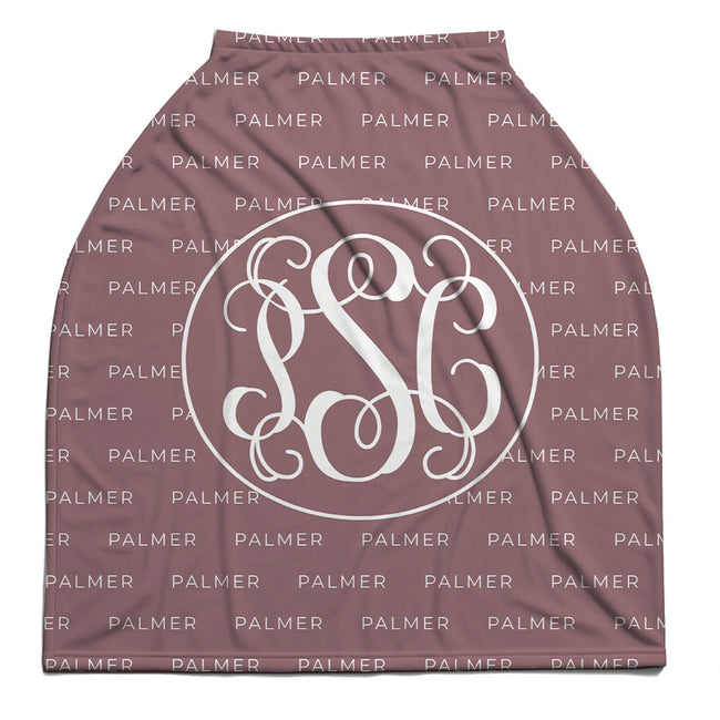 A baby car seat cover in dusty mauve color, featuring a repeating white 'PALMER' brand watermark pattern and a large white circular monogram design in the center.