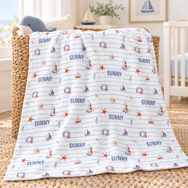 Personalized Nautical Stripe Baby Boy Blanket. Sailboats, lighthouses, starfish, and seahorses surround a custom name over soft blue stripes.