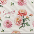 Closeup of a personalized lightweight fleece blanket with peach and pink chrysanthemums and Scarlett Mae lettering.