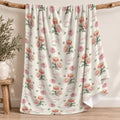 Ivory blanket with peach and pink chrysanthemums, green foliage, and the name Scarlett Mae in rose script and green lettering.