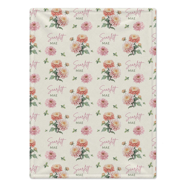 Ivory blanket with peach and pink chrysanthemums, green foliage, and the name Scarlett Mae in rose script and green lettering.
