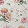 Ivory fabric with peach and pink chrysanthemums, green foliage, and the name Scarlett Mae in rose script and green lettering.