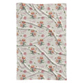 Ivory swaddle blanket with peach and pink chrysanthemums, green foliage, and the name Scarlett Mae in rose and green lettering.