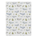 A personalized baby blanket featuring a repeating pattern of blue and gray whales, green leaves, and the name 'RILEY' printed in dark gray on a light gray background.