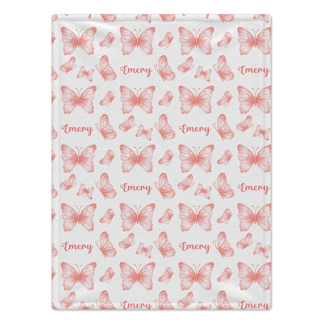 Personalized Peach Butterfly Baby Girl Blanket. Delicate peach-pink watercolor butterflies surround a custom name in a light, graceful design.