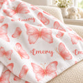 Personalized Peach Butterfly Baby Girl Blanket. Delicate peach-pink watercolor butterflies surround a custom name in a light, graceful design.
