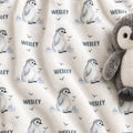 Personalized Penguin Baby Blanket. Sweet baby penguins, icy landscape accents, and little flying birds surround a custom name on a white background.