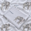 Folded Little Elephant personalized swaddle blanket showing a gray watercolor elephant and Cooper in slate blue lettering.