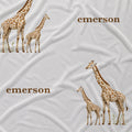 Close-up of Little Giraffe fabric with watercolor adult and baby giraffes and the name Emerson in brown on white.