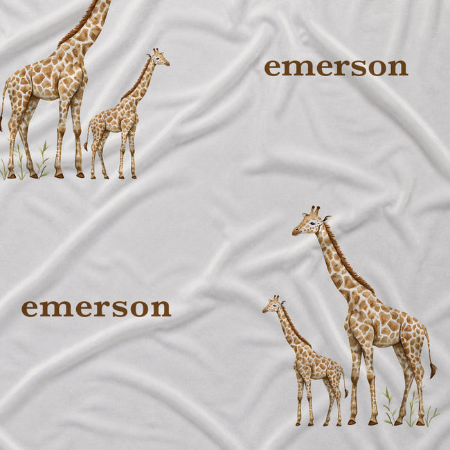 Close-up of Little Giraffe fabric with watercolor adult and baby giraffes and the name Emerson in brown on white.