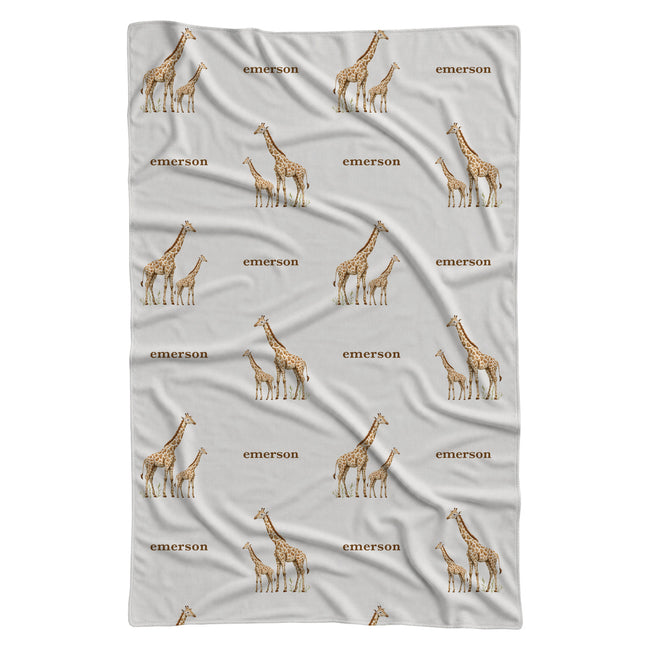 Full view of Little Giraffe personalized swaddle blanket with watercolor adult and baby giraffes and the name Emerson on white.