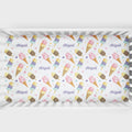 A crib bumper sticker or insert featuring a repeating pattern of colorful watercolor ice cream cones, cherries, hearts, and the name 'Abigail' in purple script, displayed inside a white wooden crib.