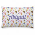 A pillow with a white background covered in a pastel ice cream cone pattern, featuring the personalized name 'Abigail' in large purple script across the center.