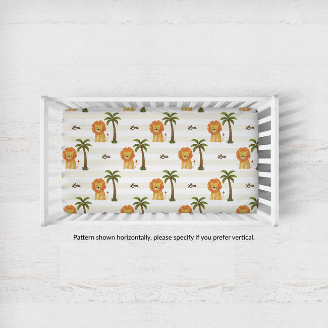 Little Lion crib sheet personalized with Leo, shown horizontally in a white crib; caption notes vertical pattern orientation is available by request.
