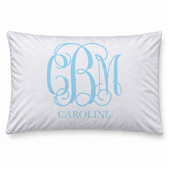 A white rectangular pillowcase featuring a light blue monogram design with the letters 'CBM' and the name 'CAROLINE' printed below, shown against a plain white background.