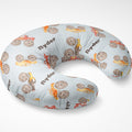 Angled view of the Monster Trucks nursing pillow cover personalized with Ryder, featuring colorful watercolor trucks on pale blue.