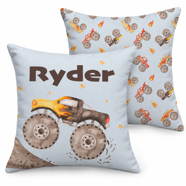 Front and back views of the Monster Trucks throw pillow, with Ryder above a yellow and charcoal truck in front and a repeating watercolor truck pattern behind.
