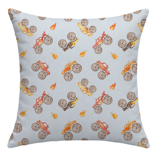 Back of the Monster Trucks throw pillow featuring a repeating pattern of colorful watercolor trucks and orange flames on pale blue.