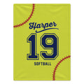 A personalized softball-themed blanket or towel featuring a bright yellow background with a navy blue and yellow number 19, the name Harper in script, the word SOFTBALL, and red baseball stitching details.