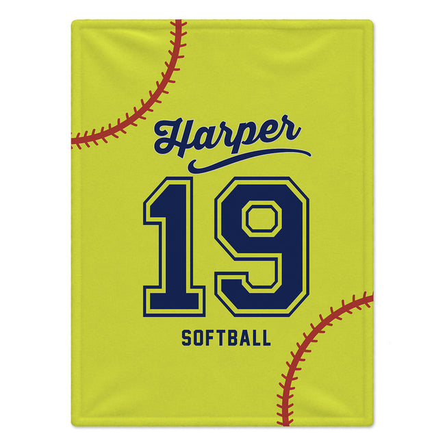 A personalized softball-themed blanket or towel featuring a bright yellow background with a navy blue and yellow number 19, the name Harper in script, the word SOFTBALL, and red baseball stitching details.