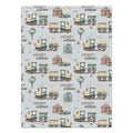 A personalized baby blanket featuring a repeating pattern of vintage toy trains, small houses, trees, and the text 'HENRY william' on a light gray background.