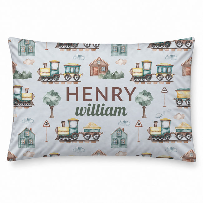 A personalized rectangular pillow featuring a watercolor-style train pattern on a light gray background, with the custom text 'HENRY william' printed in the center.