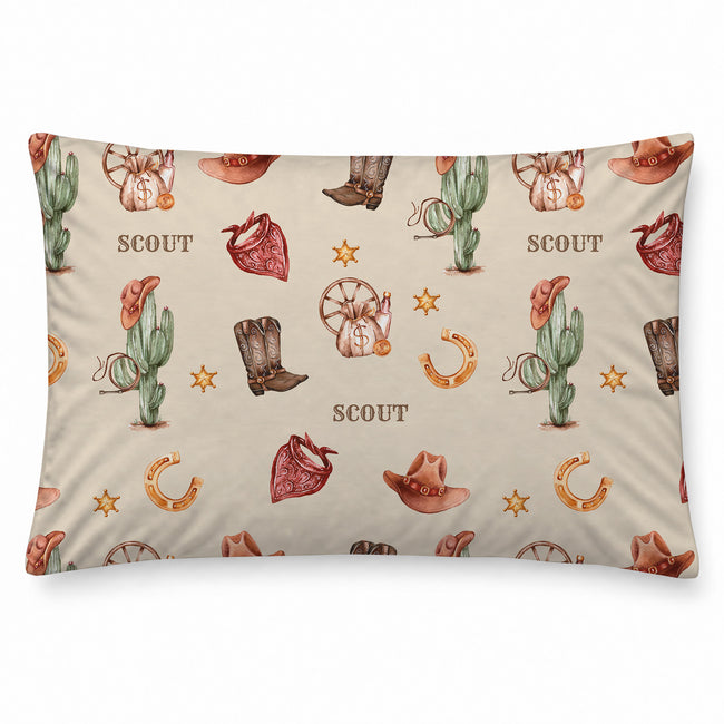 Wild West pillowcase personalized with Scout, featuring watercolor cowboy boots, hats, cacti and red bandanas on cream.
