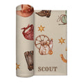 Partially rolled Wild West swaddle blanket with Scout lettering, cowboy boots, a wagon wheel and golden sheriff stars.
