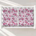 A white changing table with a personalized changing pad cover featuring a pink and gray fire truck pattern with the name 'HALLIE' repeated. 