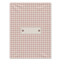 A rectangular pink and white gingham dog blanket featuring a central cream-colored label with two brown paw prints, shown flat against a white background.