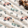 Personalized Race Car Baby Blanket. Vintage-style race cars in coral and mint, trophies, and checkered flags surround a custom name.