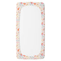 A personalized fitted sheet with a rounded top and bottom, featuring a pastel unicorn patterned border on a white background.
