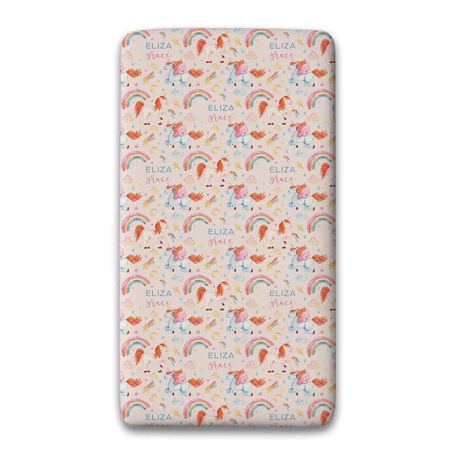 A custom sheet set with rounded corners, featuring a repeating pattern of orange unicorns, pastel pink and blue rainbows, and the text 'ELIZA Grace' on a light cream background.