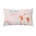 A personalized rectangular pillow featuring a watercolor-style white unicorn with a pink and orange mane, a rainbow, stars, and the names 'ELIZA' and 'grace' printed on a pale pink background.