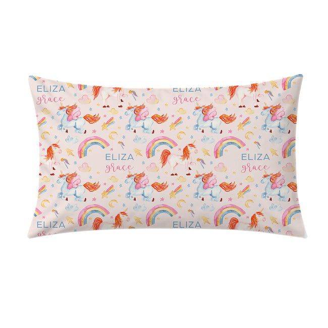 A rectangular decorative pillow featuring a whimsical repeating pattern of unicorns, rainbows, stars, and hearts on a pale pink background, with the text 'ELIZA grace' printed in blue and pink.