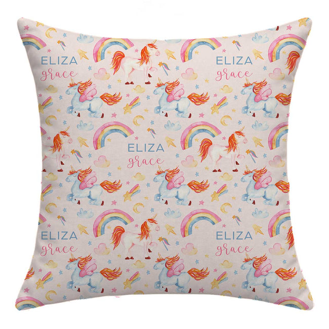 A square throw pillow featuring a colorful repeating pattern of unicorns, rainbows, stars, hearts, and the personalized text 'ELIZA Grace' on a light cream background.