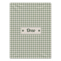 A rectangular pet blanket with a sage green and cream gingham checkered pattern, featuring a central cream label with the name 'Oreo' and paw prints.