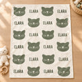 Personalized Sage Cat Baby Blanket. Sage green cat silhouettes surround a custom name in a simple, modern design on a light background.