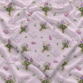 Mauve-pink swaddle blanket with lavender aster bouquets, golden centers, green leaves, and the name Evelyn Claire.