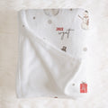 A white personalized baby blanket with a soft fleece reverse side, decorated with a snowman, a small snowman hat, a red gift box, and the custom name 'Jack Wyatt' in red and black script. The blanket is styled flat on a white faux fur background.