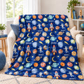 Space Explorers personalized blanket draped over an ivory loveseat, with Scout lettering, watercolor planets, rockets, and astronauts.