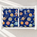 Space Explorers changing pad cover personalized with Scout, featuring watercolor planets, rockets, and astronauts on a navy starry background.