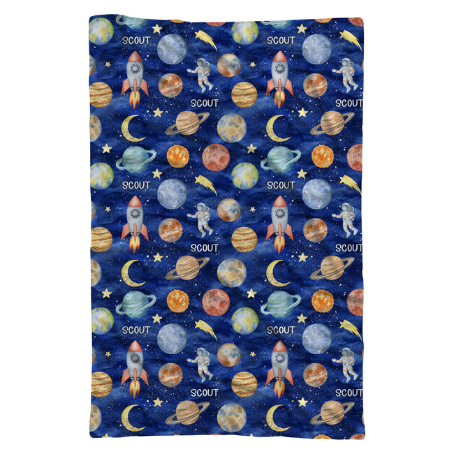 Full view of the Space Explorers swaddle blanket personalized with Scout, featuring watercolor planets, astronauts, moons, and stars.
