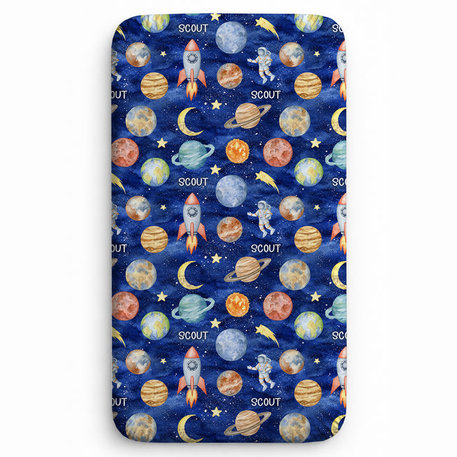 Space Explorers twin sheet personalized with Scout, featuring watercolor planets, rockets, astronauts, and golden moons on a navy starry background.