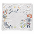 Personalized watercolor space baby milestone blanket with astronauts, rocket, planets, stars, custom name, and months 1–12