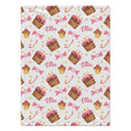 A personalized blanket featuring a repeating pattern of pink frosted cupcakes, pink lollipops, and the name 'Ellie' in pink script on a white background.