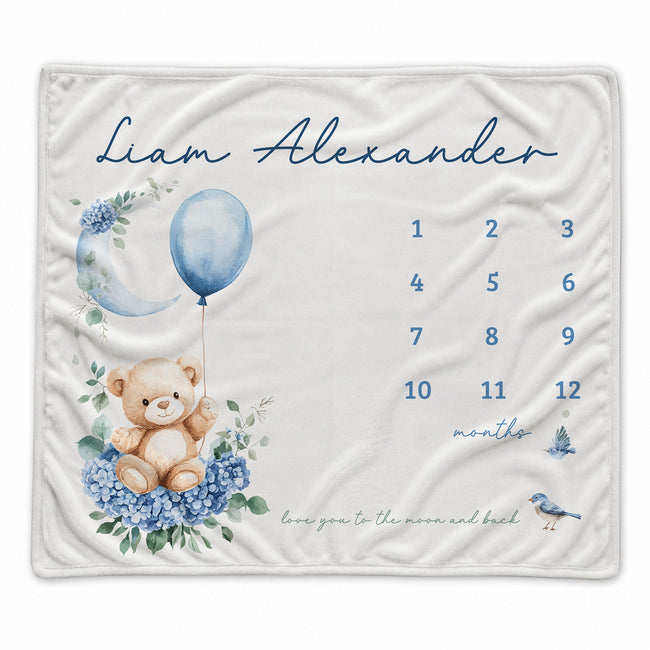 Baby boy milestone blanket personalized with Liam Alexander, featuring a teddy bear, blue balloon, floral moon, and monthly number grid.
