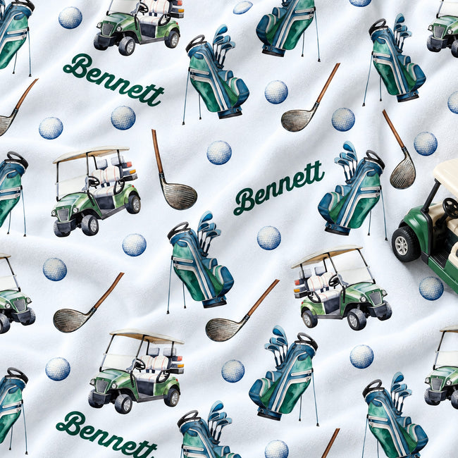 Personalized golf-themed fabric print featuring green and teal golf carts, golf bags, golf clubs, golf balls, and the name 'Bennett' in green script on a white background.