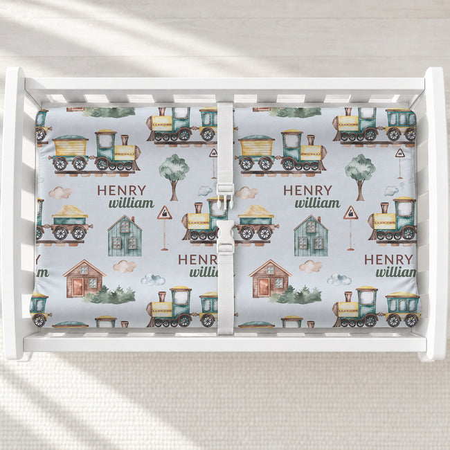 Watercolor Trains Personalized Changing Pad Cover, featuring charming trains and your baby’s name for a storybook-inspired nursery.